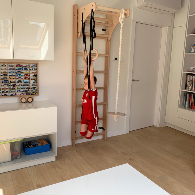 Boy using wall bars