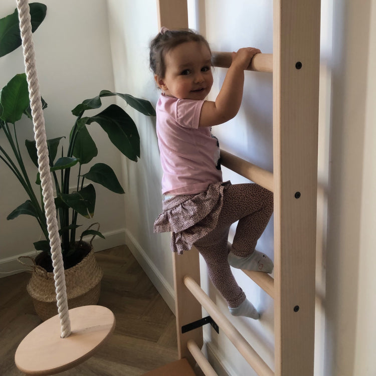 Girl using wall bars